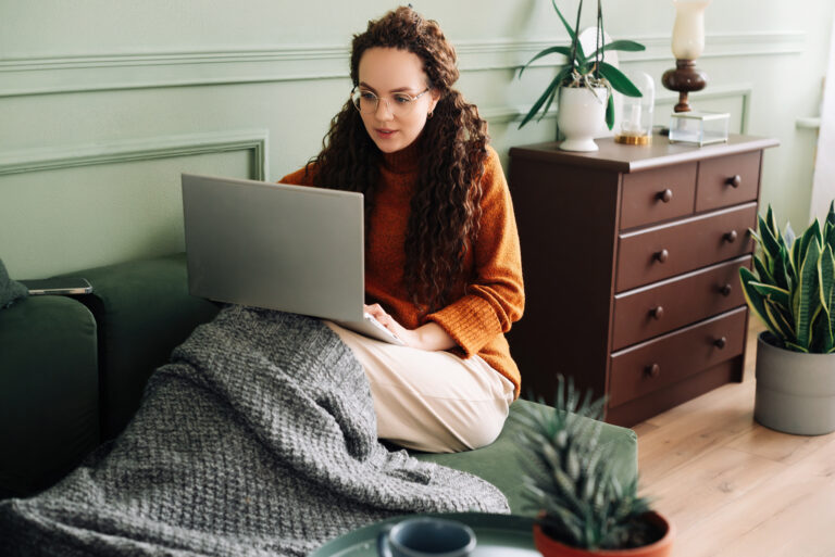 Woman in online therapy session at home with a Texas-based virtual counselor